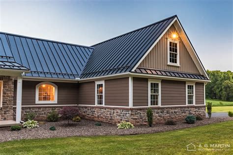 brown house with black metal roof|ranch homes with black roof.